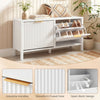 Narrow white shoe storage bench with fluted doors, adjustable shelves, and elegant handles for entryway organization.