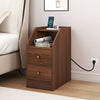 Side end table in walnut with charging station, open shelf, and two drawers for organized storage beside a sofa.