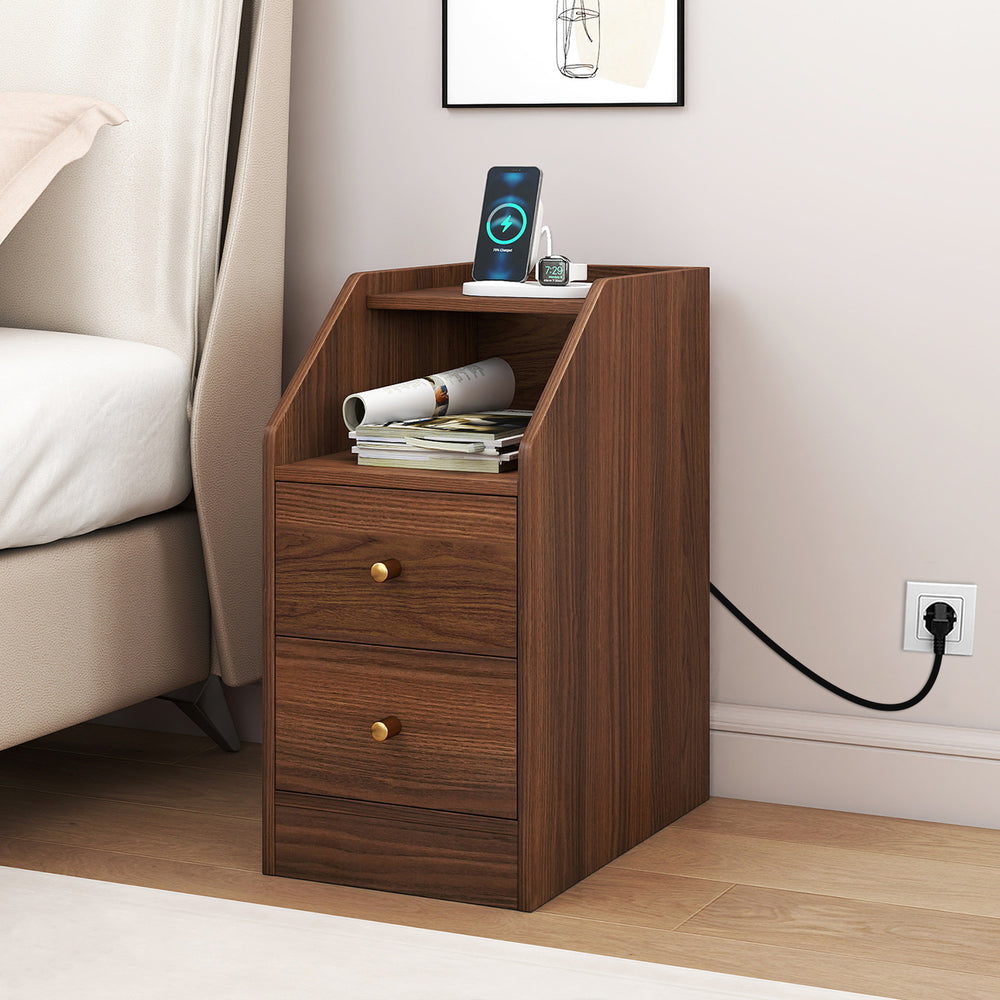Side end table in walnut with charging station, open shelf, and two drawers for organized storage beside a sofa.