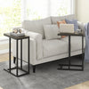 C-shaped side table with oak finish and metal frame, perfect for laptops or tea, placed beside a sofa.