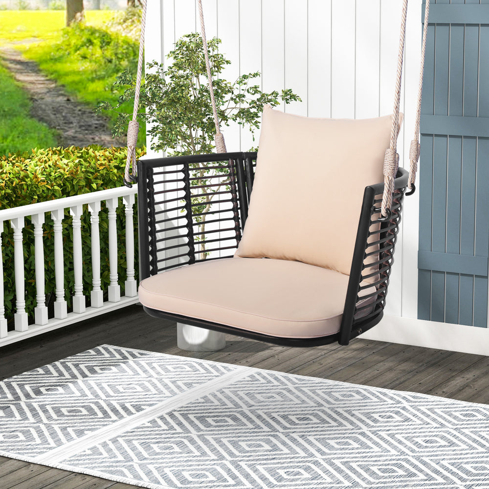 Single person hanging seat with woven rattan backrest, soft cushions, ideal for backyard relaxation.
