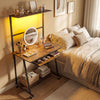 Small computer desk in rustic brown with LED lights, charging station, and wheels, ideal for bedrooms or small spaces.
