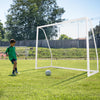 8' x 6' soccer goal made of weather-resistant UPVC pipes, shown in use with a child kicking a soccer ball on grass.