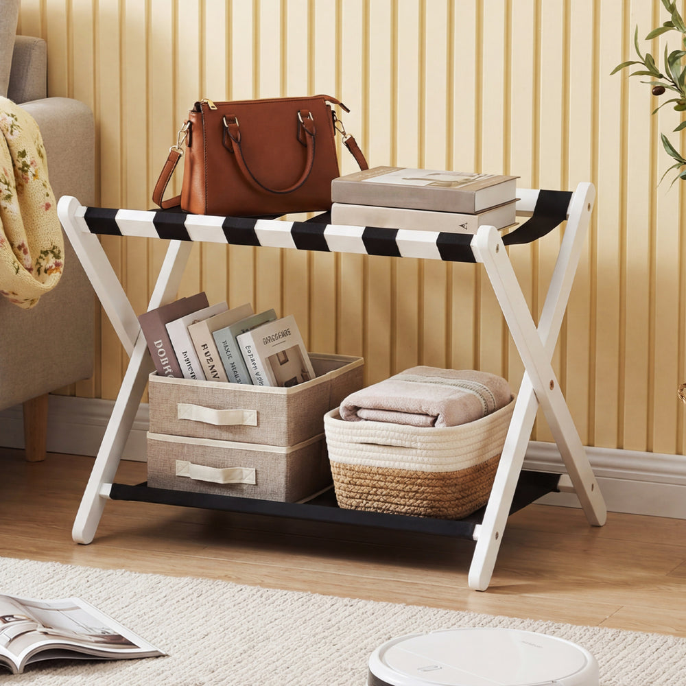 Folding luggage rack in white with solid rubberwood frame and nylon shelves, ideal for organizing bags and travel.
