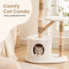 Cozy beige cat condo with real wood branches, scratching posts, and a plush top perch for climbing and lounging.