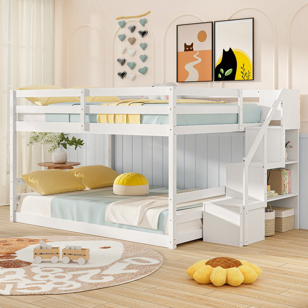 Solid wood full over full low bunk bed in white with integrated storage stairs, ideal for kids' rooms and sleepovers.