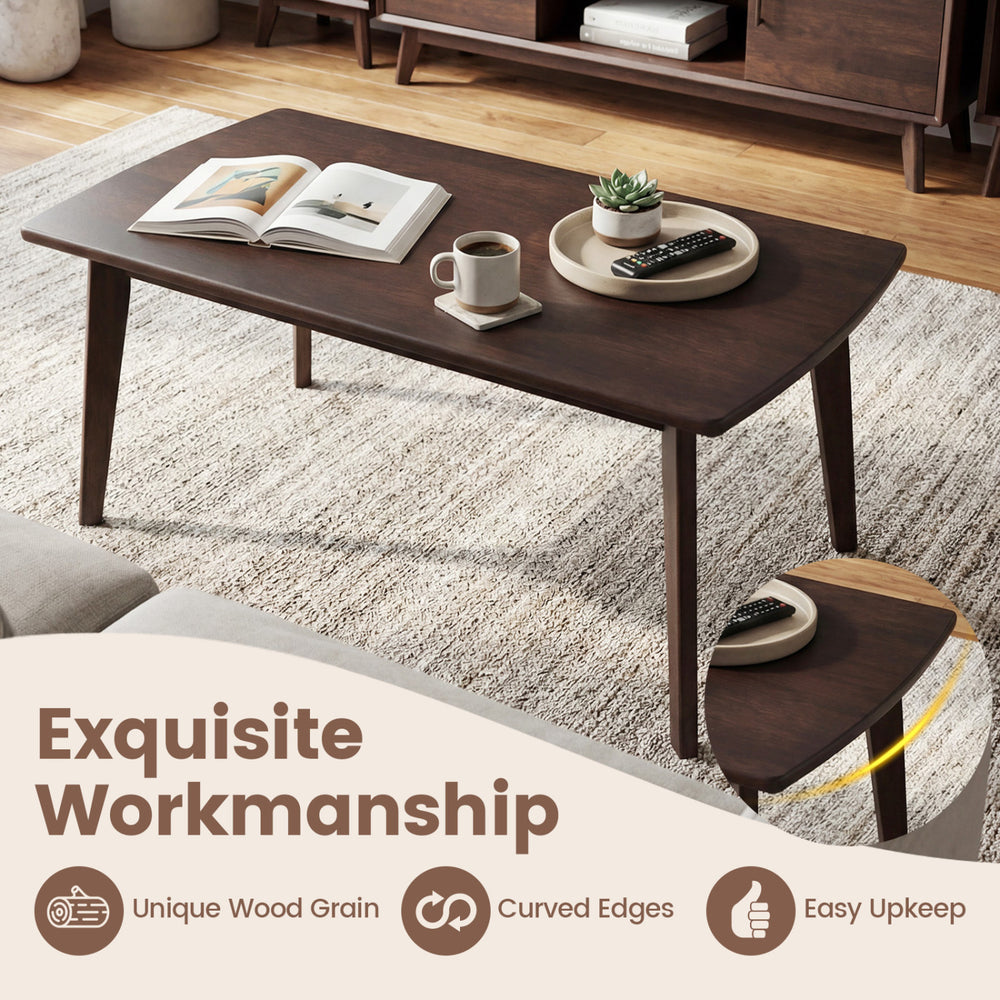 Solid wood coffee table with tapered legs, unique wood grain, and curved edges for easy upkeep in walnut finish.