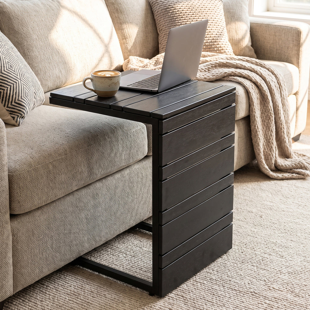 C-shaped side table with a sleek black finish, designed for easy placement beside sofas or beds in indoor and outdoor settings.