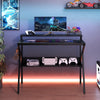 Space-saving black computer desk with monitor stand, extra storage shelf, and gaming accessories for organized work or.