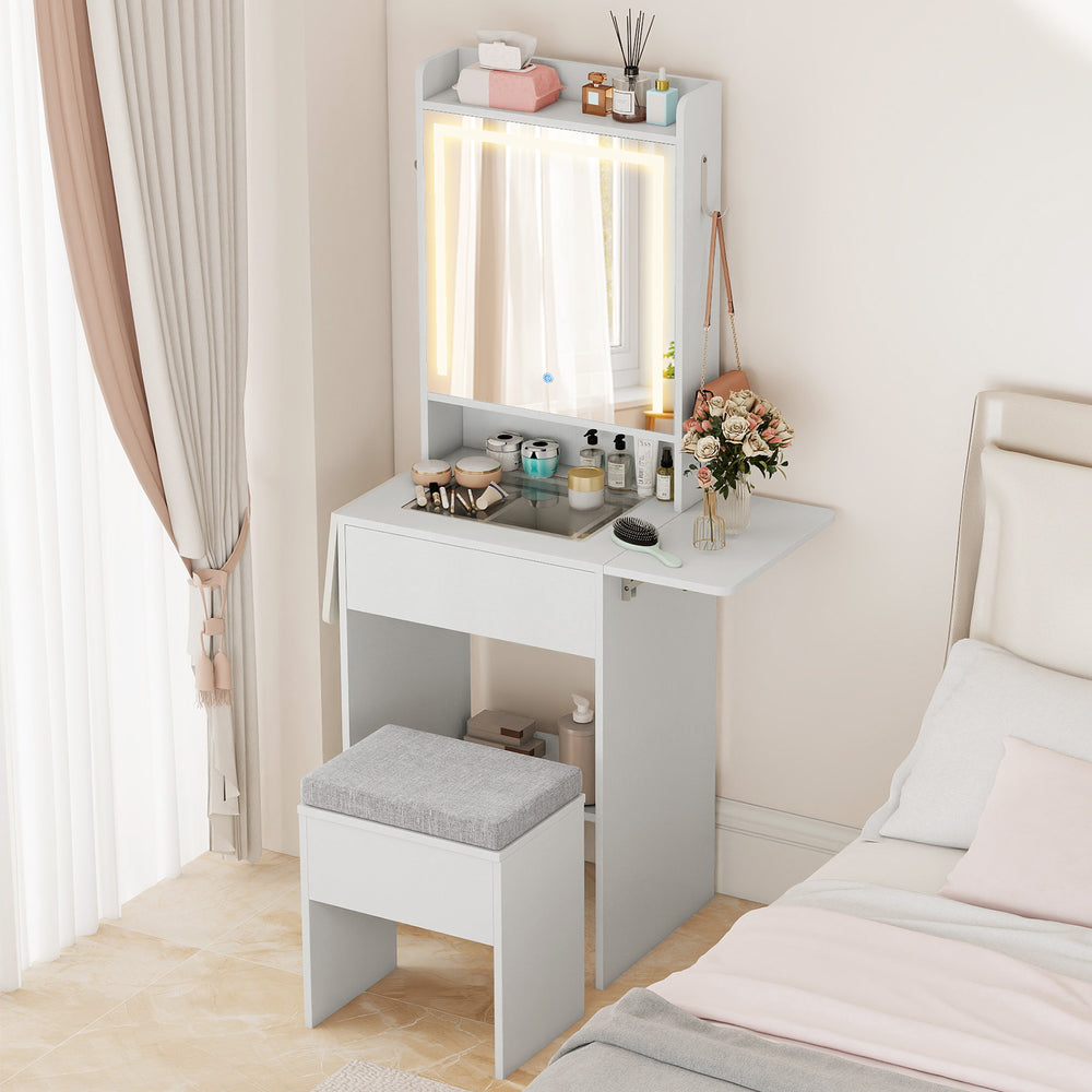Space-saving white vanity desk with LED-lit mirror, adjustable shelf, and stool for organized bedroom beauty essentials.