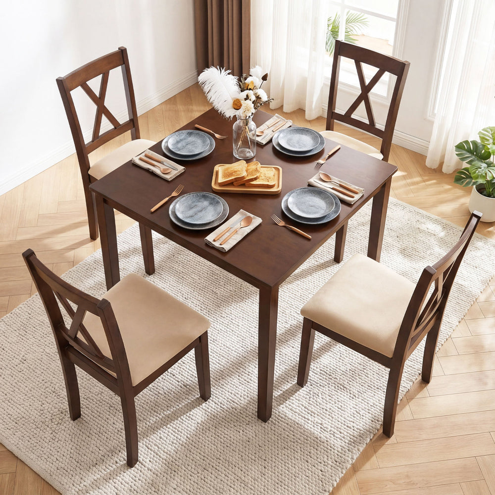 Square walnut kitchen table set with four armless chairs, elegantly arranged for dining in a bright room.