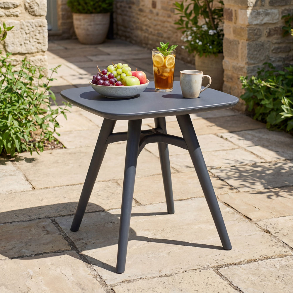 Gray square outdoor dining table made of all-weather plastic, perfect for intimate meals in the garden or patio.