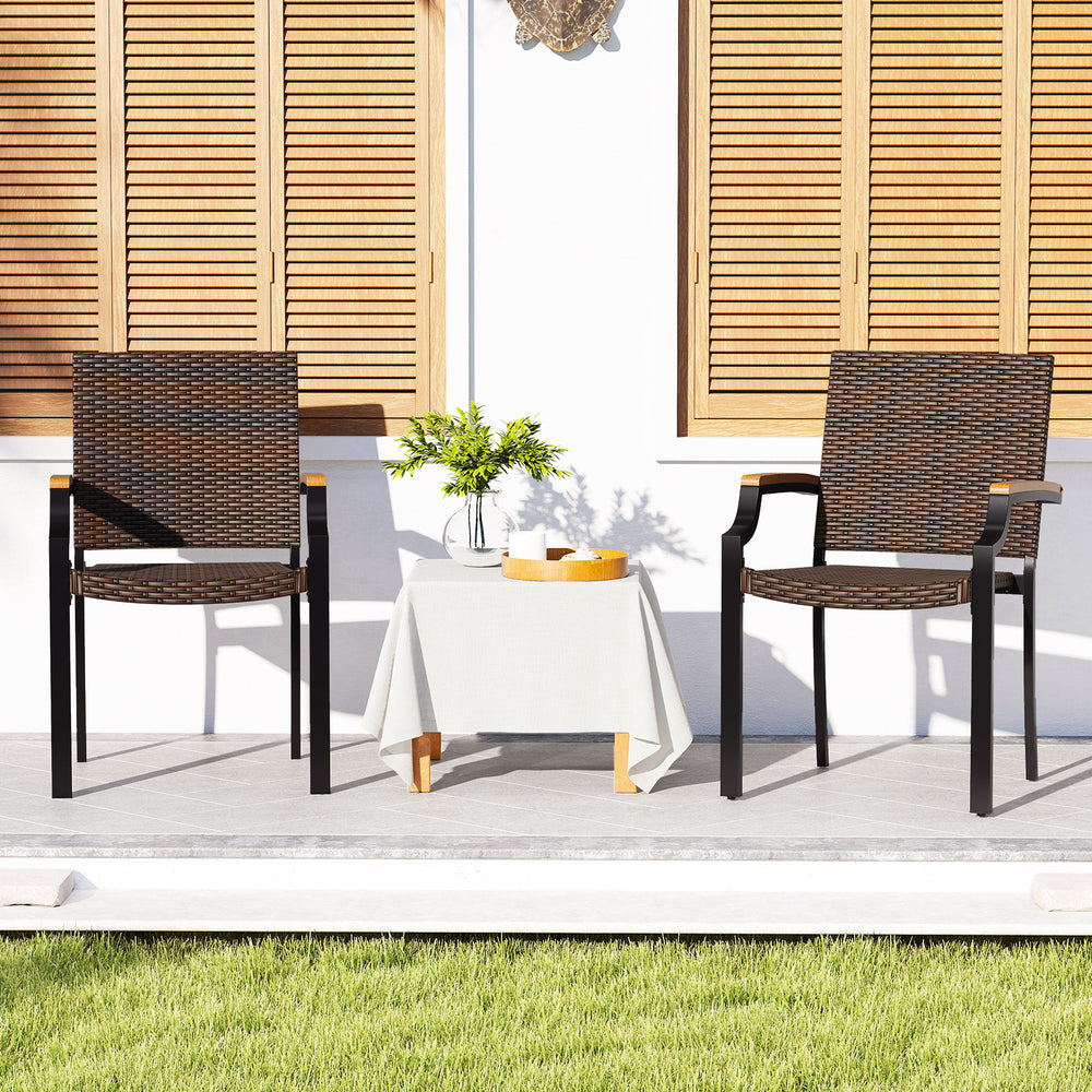 Stacking wicker chairs set of 2 with acacia wood armrests, perfect for outdoor patio dining and space-saving storage.