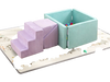 Soft play set featuring purple climbing blocks and a ball pit, ideal for toddlers' imaginative play in a nursery.