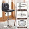 Black swivel bar stool with adjustable height, chrome metal base, and integrated footrest for kitchen or dining room.