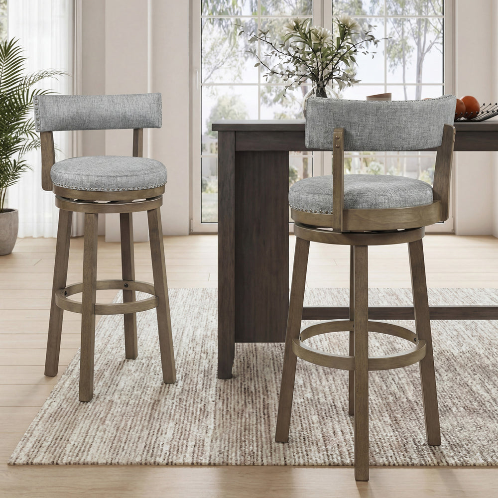 Side view of a swivel bar stool with a round footrest and stylish nailhead trim, perfect for dining rooms or home bars.