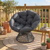Round wicker swivel Papasan chair with thick grey cushion, perfect for outdoor relaxation on patios or in living rooms.
