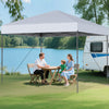 Pop-up canopy tent set up by a lake, featuring a white oxford canopy for sun protection and easy portability.