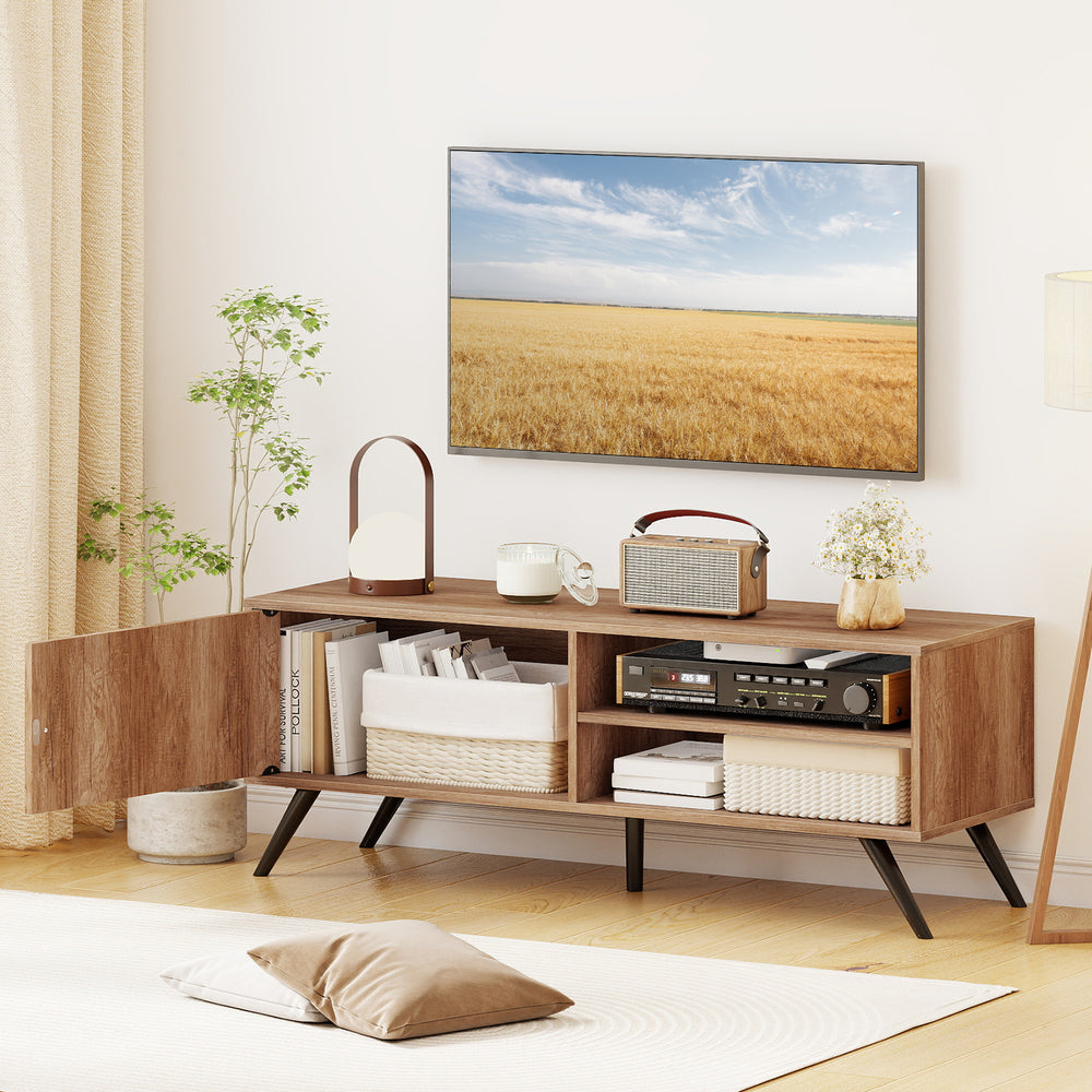 Mid-century modern TV stand in oak with 5 raised legs, showcasing open storage for media items and a stylish design.