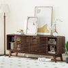 Close-up of the walnut TV stand's sliding doors and adjustable shelves, highlighting mid-century design and.