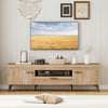 TV stand in oak finish with 2 cabinets and storage drawer, designed for 65-inch TVs, offering ample storage and cable.