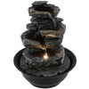 Tabletop water fountain with LED light, showcasing a close-up of the textured rock tiers for a soothing indoor.