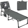 Folding tanning chair in gray with face and arm holes, adjustable backrest, and storage pockets for outdoor use.