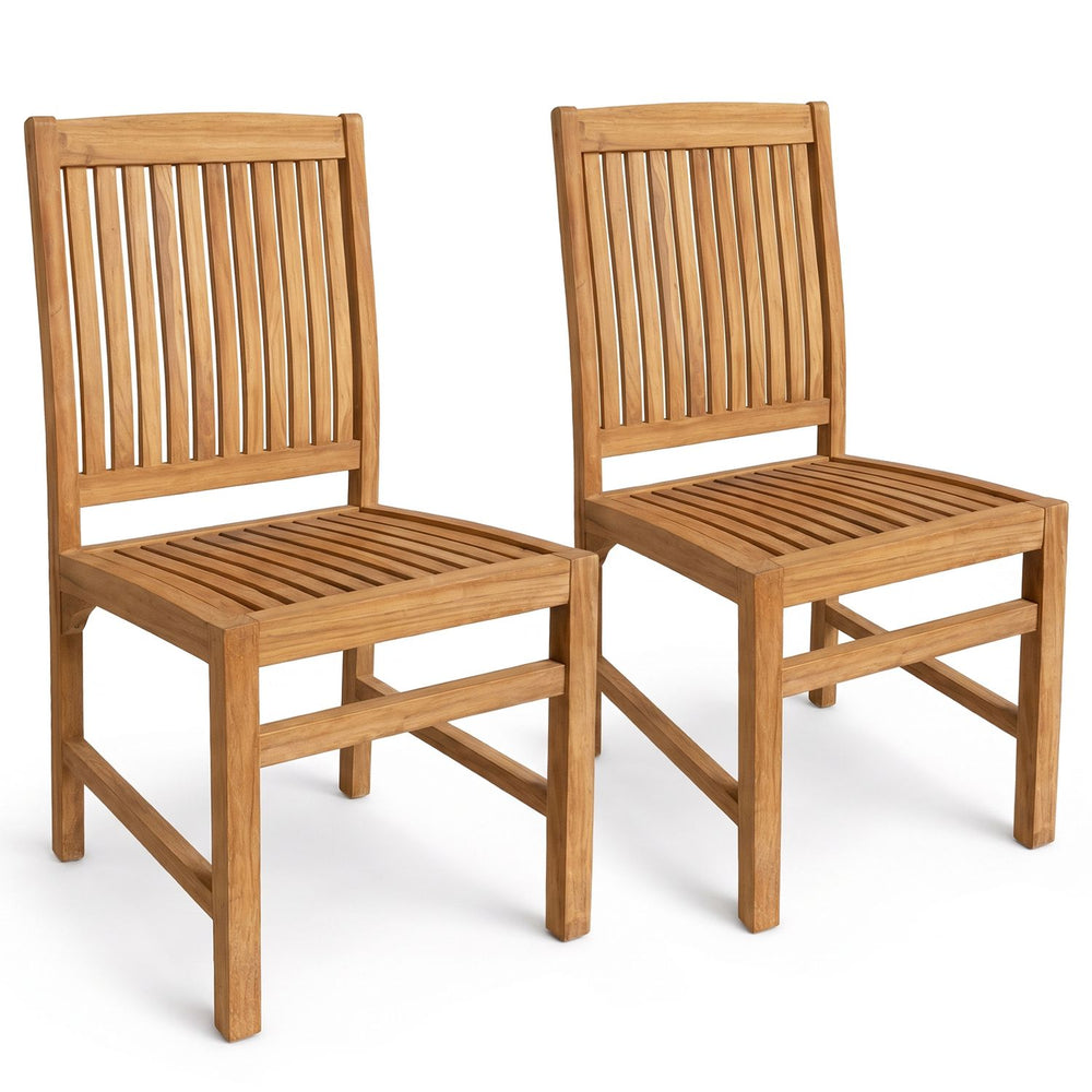 Pair of teak wood armless dining chairs with slatted seats and H-shaped footrests, shown at an angle in natural teak finish.