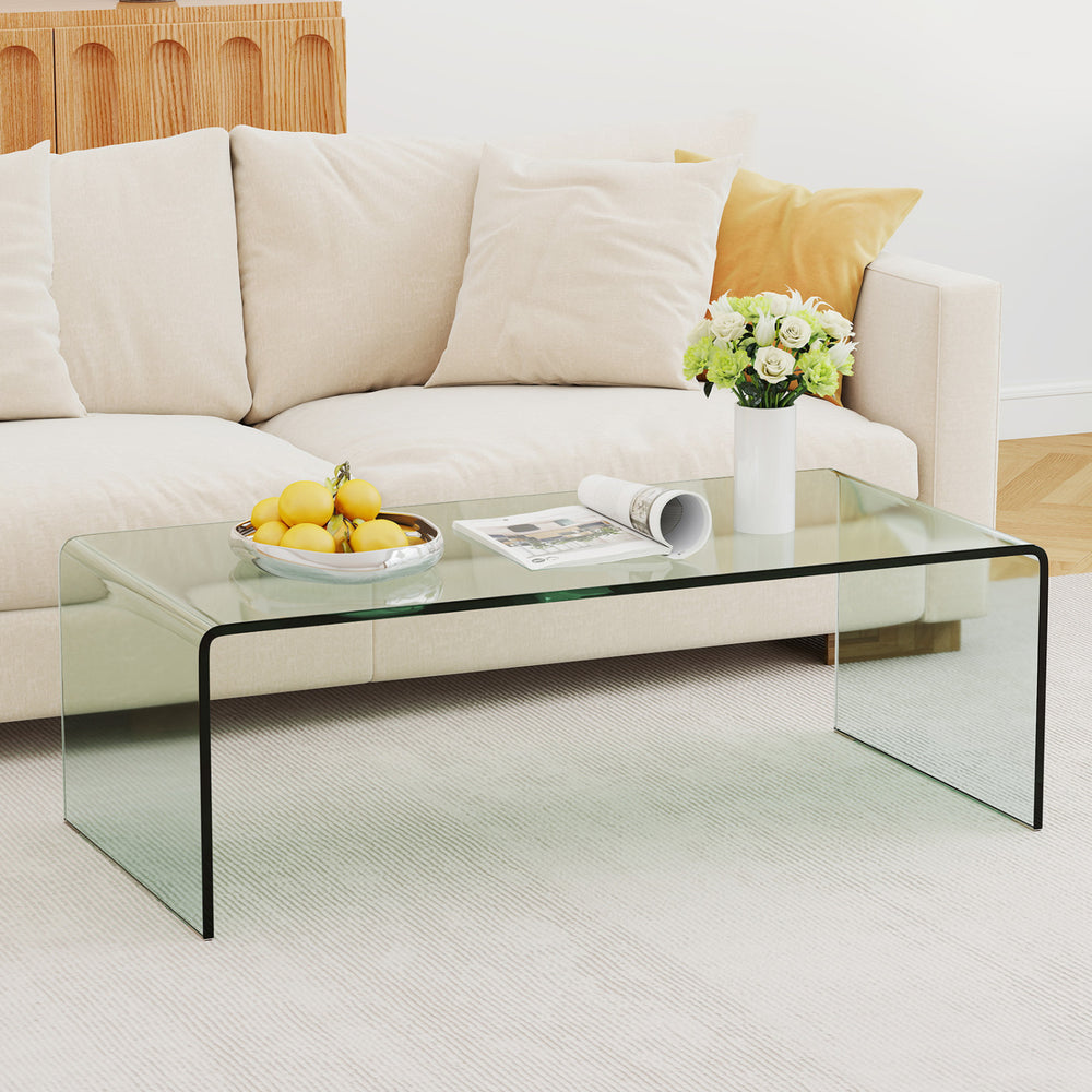 Clear tempered glass coffee table with minimalist design, ideal for living room or office use, showcasing a tidy.