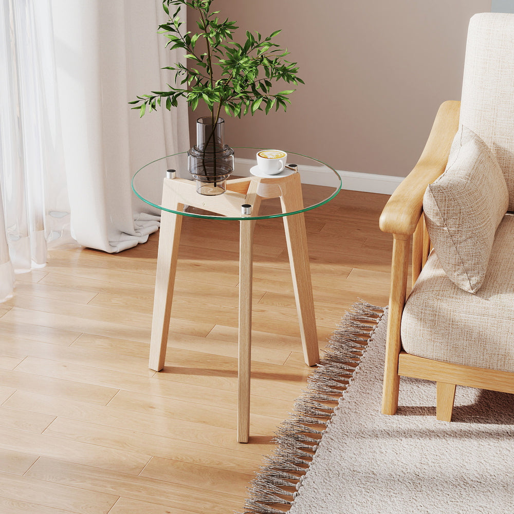 Round tempered glass end table with solid rubber wood legs, perfect as a bedside or coffee table for minimalist decor.