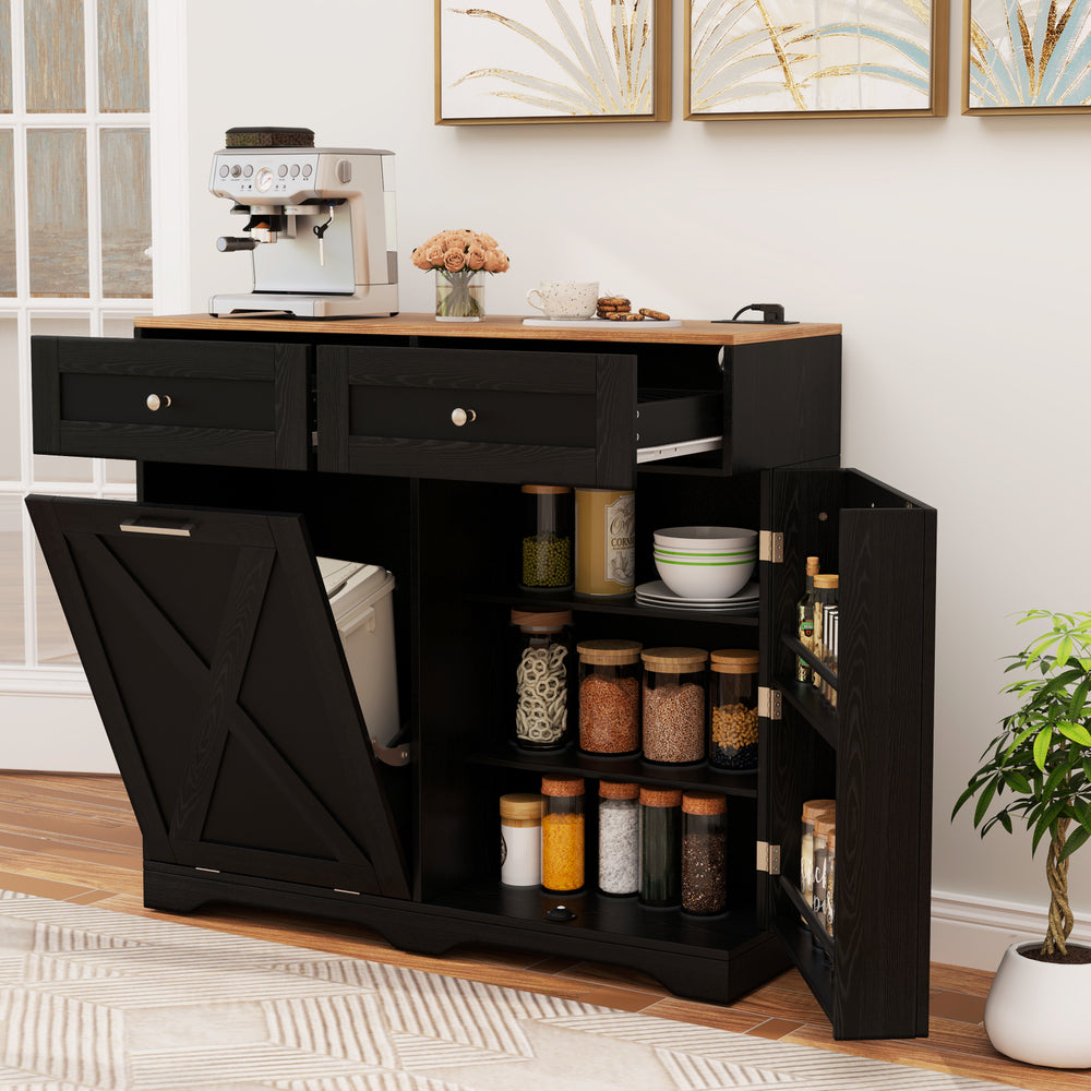 Tilt-out trash can cabinet in black with adjustable shelves, built-in outlets, and rustic barn-style doors for kitchen.