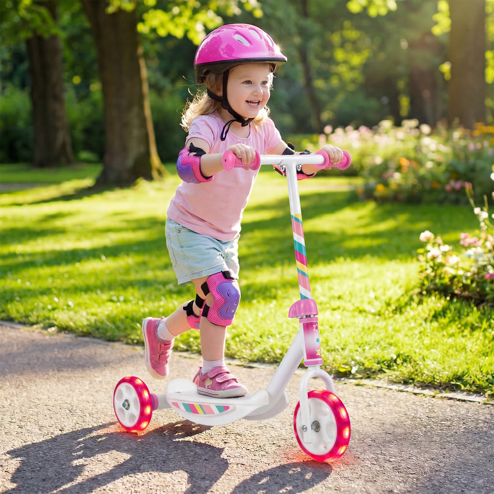 Toddler riding a pink kick scooter with LED light-up wheels and wide anti-slip deck, perfect for outdoor fun.