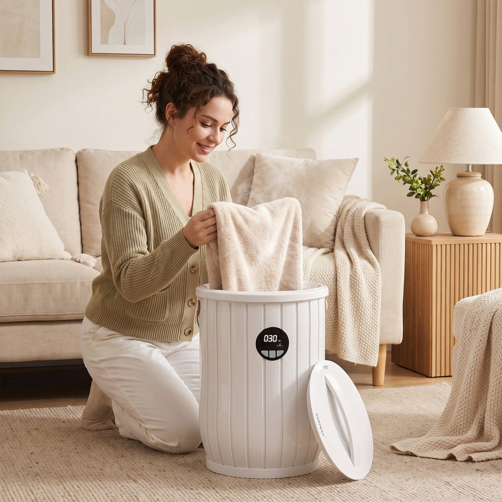A woman places a towel into the Towel Warmer Heated Bucket, featuring a 5Gal capacity and adjustable heating timer.