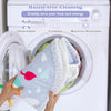 Baby play gym mat being placed in a washing machine, featuring a foldable, machine washable design for easy cleaning.