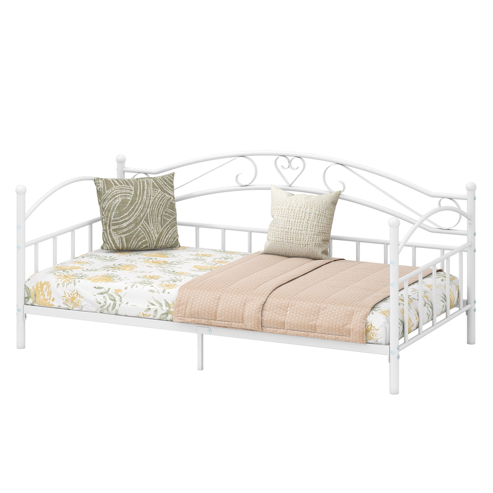 Twin size metal daybed frame in white with heart-shaped design, featuring floral bedding and pillows for cozy bedroom.