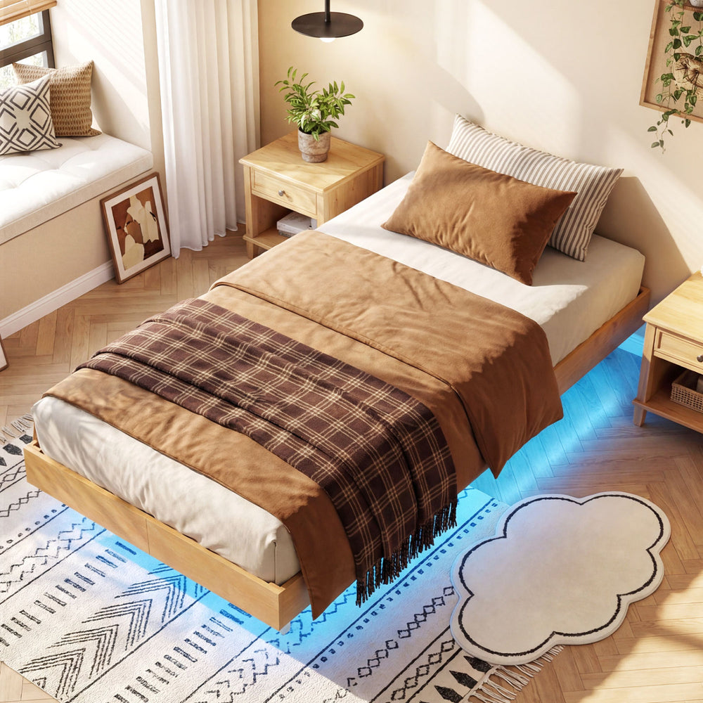 Floating bed frame with LED lights, featuring a brown throw blanket and decorative pillows, ideal for stylish bedroom.