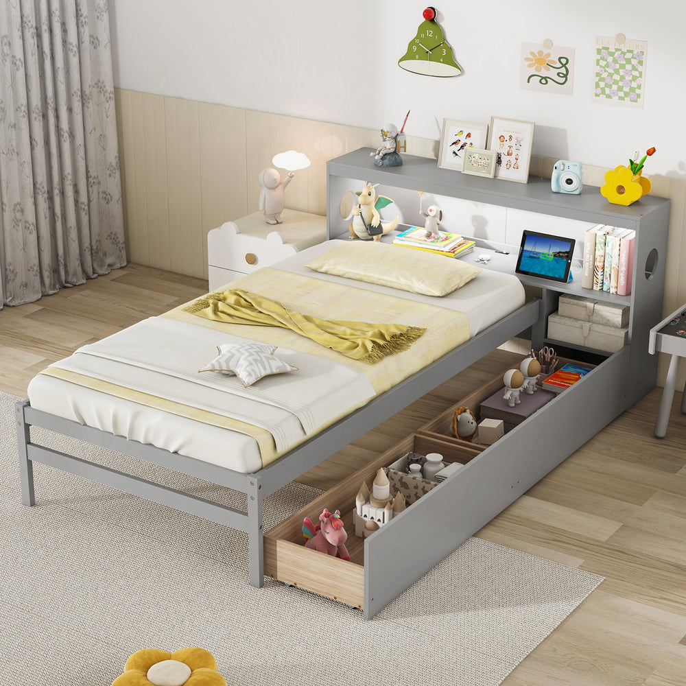 Twin size gray bed frame with LED light, bookcase headboard, and storage drawers for books and toys.