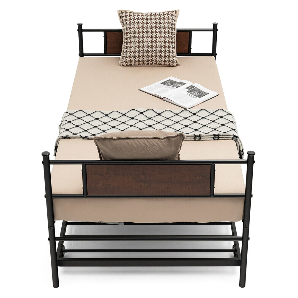 Twin size daybed frame with pullout trundle, featuring a sturdy steel design and cozy bedding for versatile sleeping.