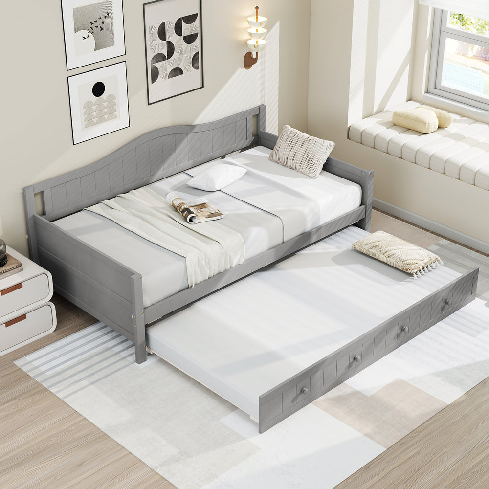 Twin size gray daybed with trundle on wheels, featuring a solid pine wood frame and elegant design for versatile use.