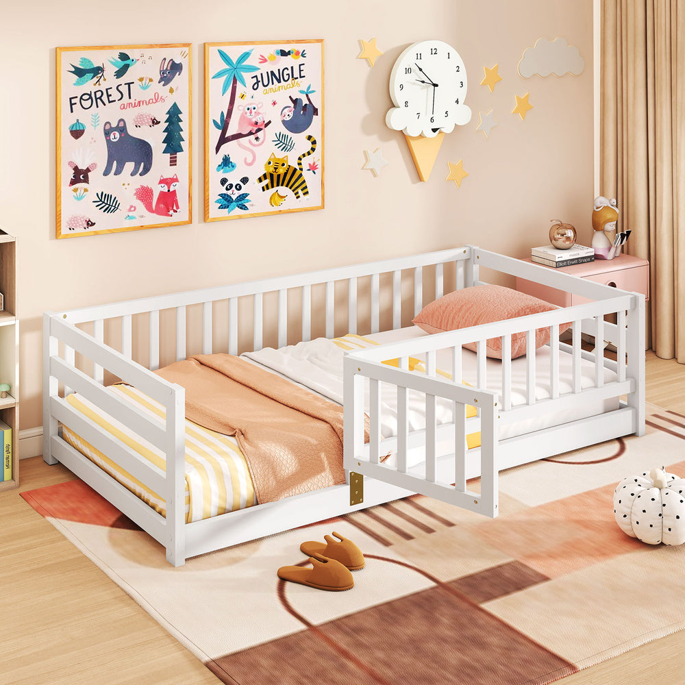 Twin size floor bed in white with high fence and door, designed for kids' safety and independence in playful spaces.