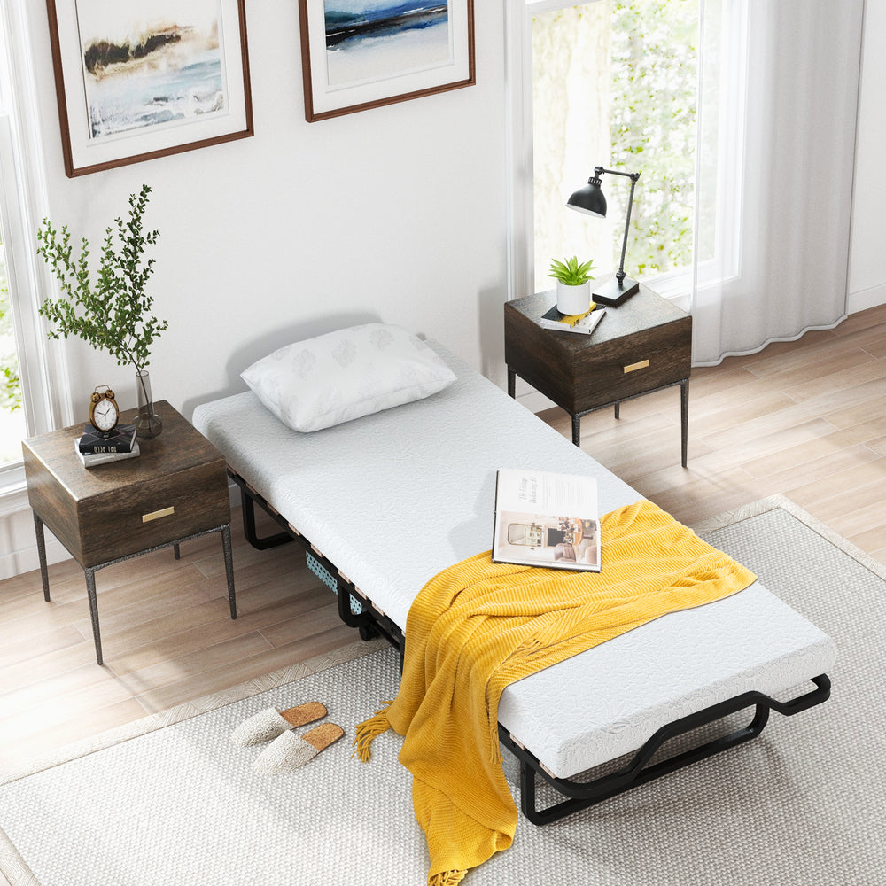 Twin size folding bed with foam mattress, lockable wheels, and a cozy yellow blanket for versatile sleeping solutions.