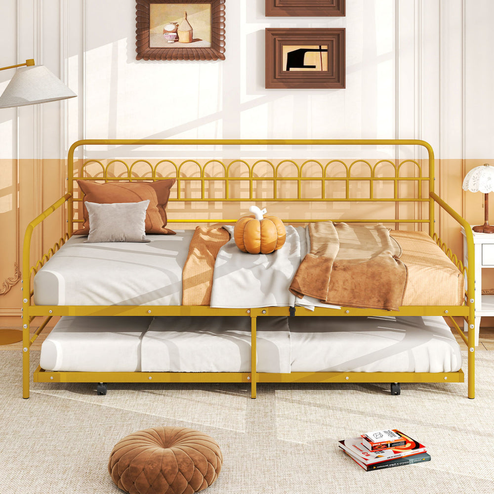 Twin size golden metal daybed with trundle and lockable wheels, ideal for maximizing space in guest rooms or living areas.