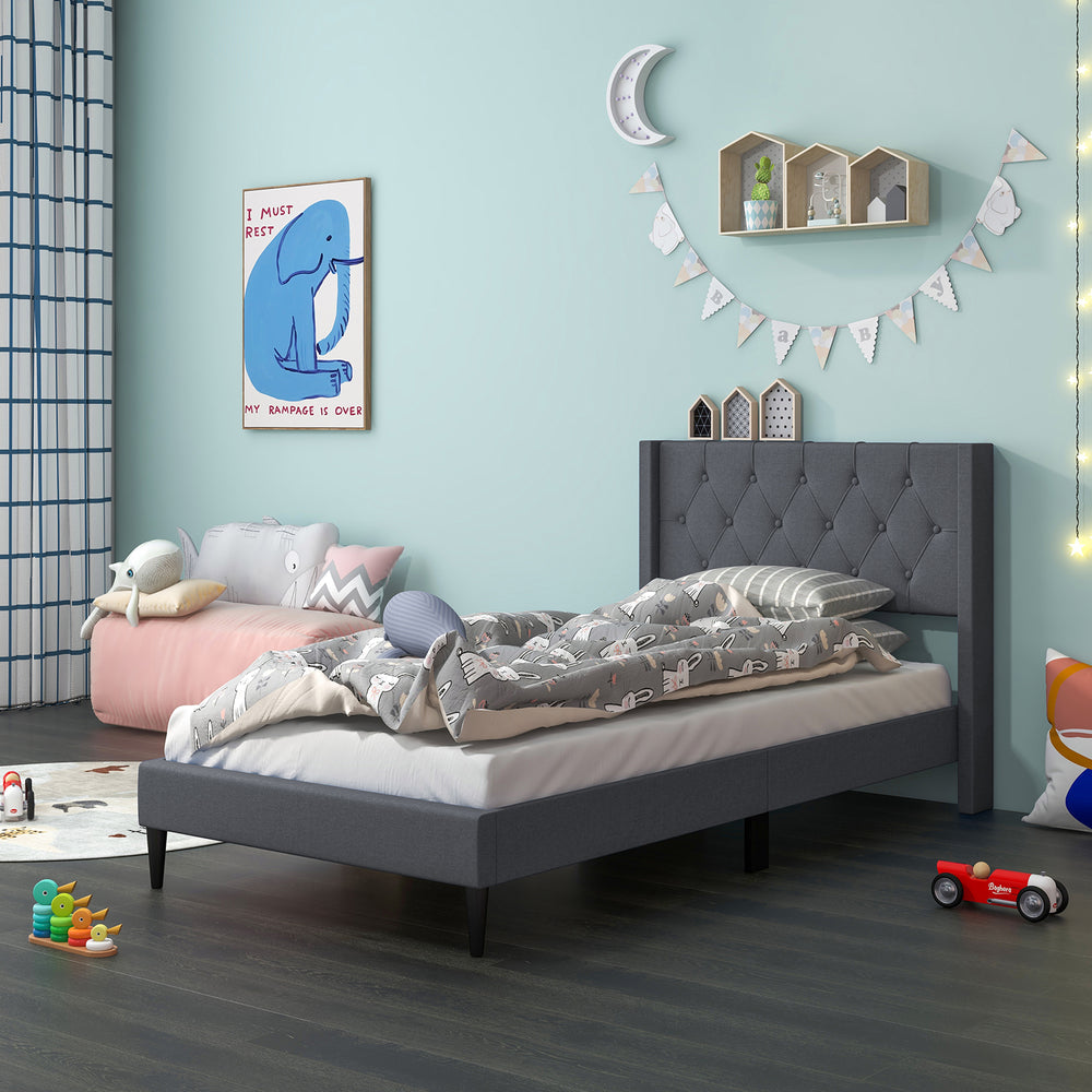 Twin size upholstered platform bed in gray with button tufted wingback headboard, ideal for bedroom or guest room.