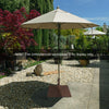 24-inch square patio umbrella base made of heavy-duty steel, featuring wheels for easy mobility and adjustable knobs.