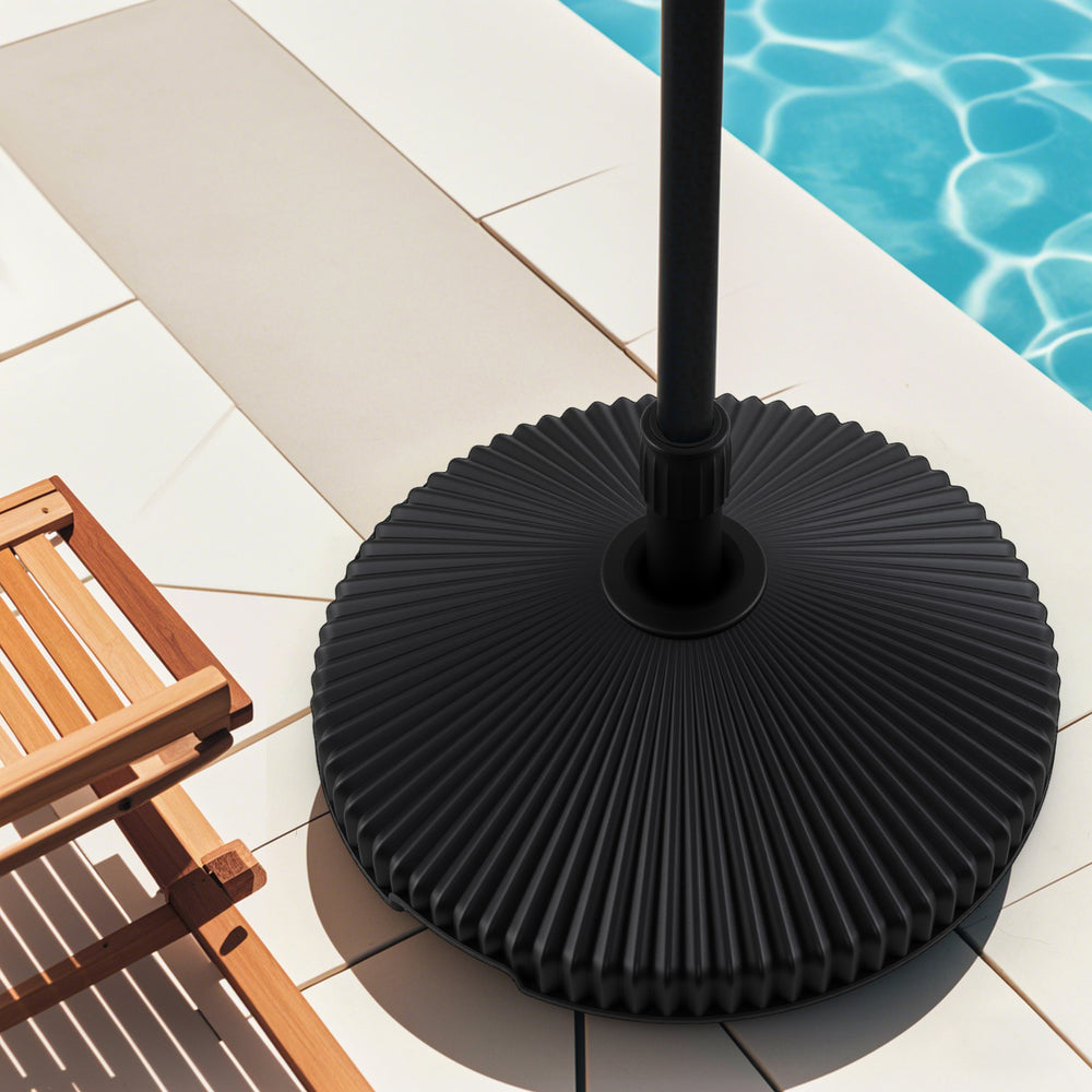 Black outdoor umbrella stand with shell texture, designed for 6-10 ft umbrellas, featuring a refillable base for.