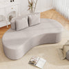 Curved gray upholstered sofa with two cozy pillows, ideal for living rooms or offices, providing comfortable seating.