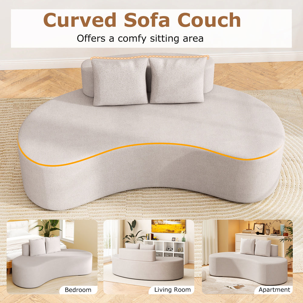 Curved gray upholstered sofa with two cozy pillows, perfect for living rooms and apartments, offers comfy seating for.