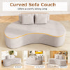 Curved gray upholstered sofa with two cozy pillows, perfect for living rooms and apartments, offers comfy seating for.