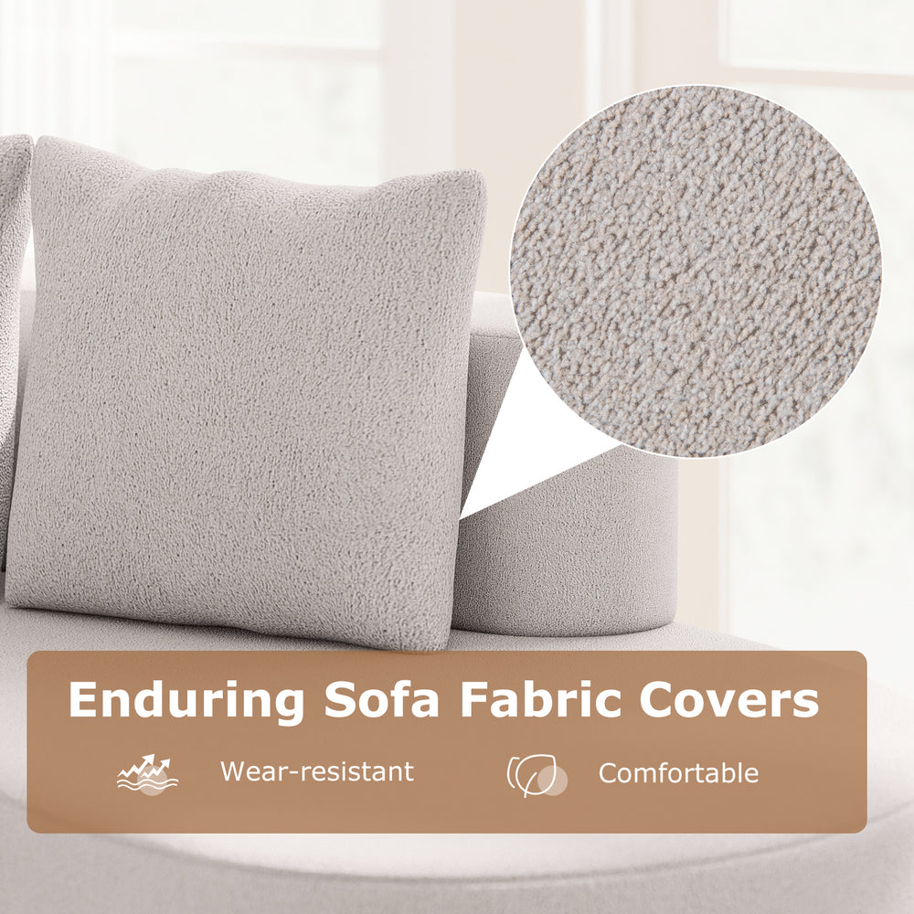 Curved gray upholstered sofa with cozy pillows, made of premium polyester fabric for comfortable living room use.