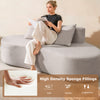 Curved gray upholstered sofa with 2 cozy pillows, featuring elastic sponge fillings for supportive comfort in any.